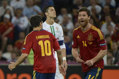 Cristiano Ronaldo reaction as Portugal misses a penalty, in Portugal vs Spain, at the same time Fabregas and Xabi Alonso celebrate in the EURO 2012