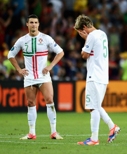 Cristiano Ronaldo smiling and showing his pants and underwear, while Fábio Coentrão cries after losing in penalties against Spain, in the EURO 2012 semi-finals