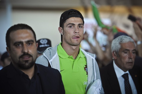 Cristiano Ronaldo licking his lips with his tongue, as he arrives to the airport after the EURO 2012