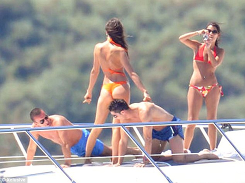 Cristiano Ronaldo doing push ups on a yacht, with a friend and Irina Shayk posing for a photo, in 2012