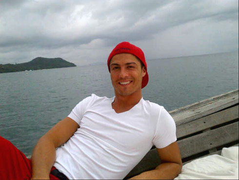 Cristiano Ronaldo on holidays in 2012, in Thailand, Phuket, traveling on a fishing boat and wearing a red cap and a white t-shirt