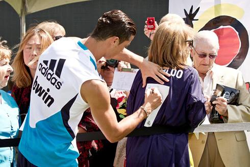 Cristiano Ronaldo signing an autograph, on a woman's jersey