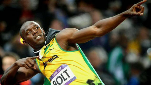 Usain Bolt celebrating his gold medal won at the London 2012 Olympics, with his classic and trademark gesture, pointing to the air while leaned to one side