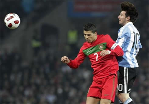 Cristiano Ronaldo and Lionel Messi jumping and disputing the same ball in the air, in Argentina vs Portugal, in 2012