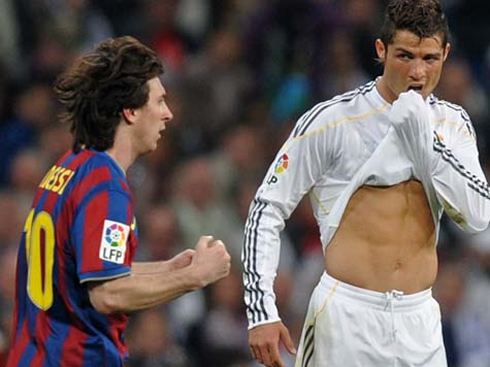 Cristiano Ronaldo pulling his shirt up, and showing his abs as he looks at Messi celebrating a goal, in 2012