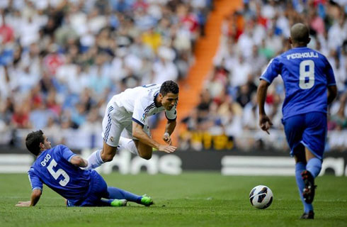 Cristiano Ronaldo about to go to the ground, after being tackled in Real Madrid vs Valencia, in 2012-2013