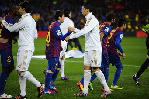Cristiano Ronaldo and Lionel Messi greeting each other, before a Real Madrid vs Barcelona game kicks off, in 2012