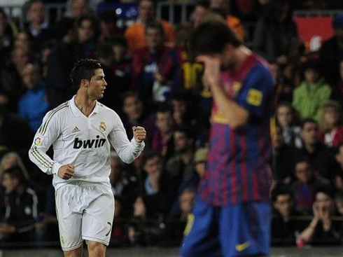 Cristiano Ronaldo celebrating a goal, while Messi cries in a Clasico between Real Madrid vs Barcelona, in 2012