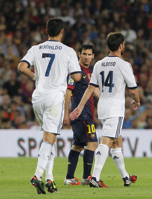 Cristiano Ronaldo and Xabi Alonso walking near Lionel Messi, in Barcelona 3-2 Real Madrid, for the Spanish Supercup first leg, in 2012