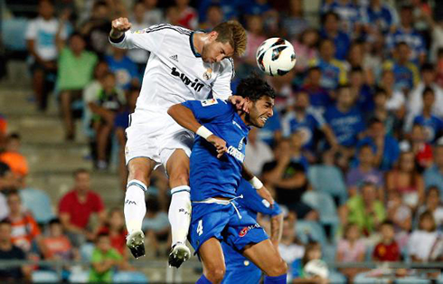 Sergio Ramos jumping high and showing his defender aggressiveness in the air, as he heads a ball in Getafe vs Real Madrid, for La Liga 2012-2013