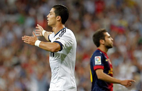 Cristiano Ronaldo waving his arms as he makes gestures to the referee, in Real Madrid vs Barcelona in 2012
