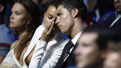 Irina Shayk showing her boobs from her sexy cleavage, as she tells Cristiano Ronaldo a secret, at the UEFA gala, in 2012