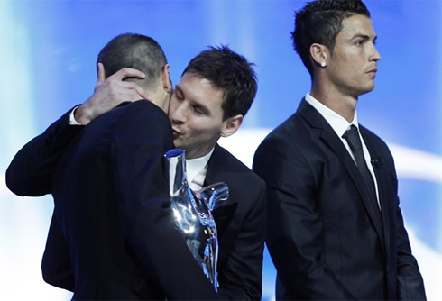 Lionel Messi giving a gay kiss on Andrés Iniesta's neck, with Ronaldo ignoring, in 2012