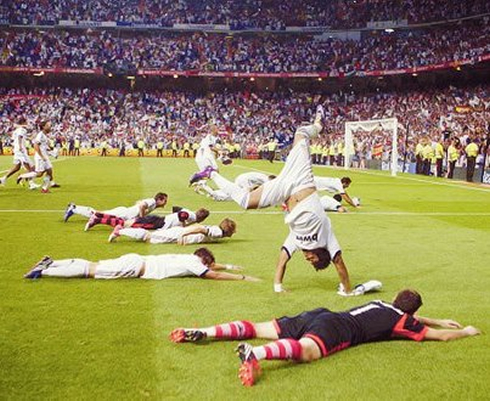 Real Madrid players celebrating the Spanish Supercup, by diving on the field, in 2012
