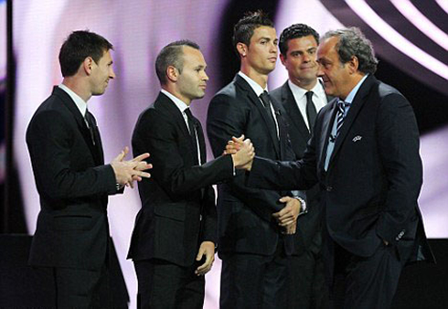 Cristiano Ronaldo side look to Michel Platini, as the Frenchman greets Iniesta and Messi, at the UEFA gala in 2012