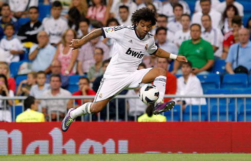 Marcelo controlling the ball in the air, during a game for Real Madrid in 2012