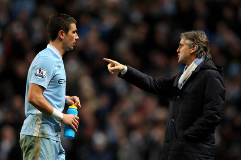 Kolarov listening to Roberto Mancini's instructions, during a Manchester City game