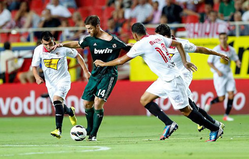 Xabi Alonso playing for Real Madrid, with the new green outfit kit and jersey, for 2012-2013