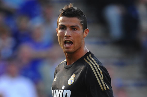 Cristiano Ronaldo playing for Real Madrid in a black jersey, kit and uniform
