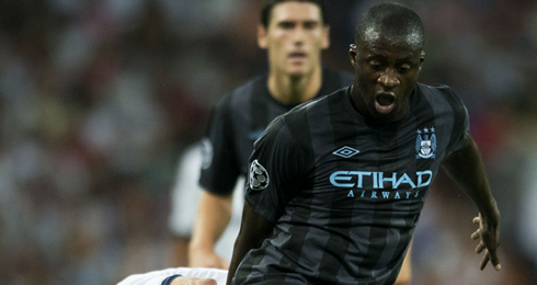 Yaya Touré playing with the new Manchester City black jersey, kit and uniform, against Real Madrid in 2012-2013