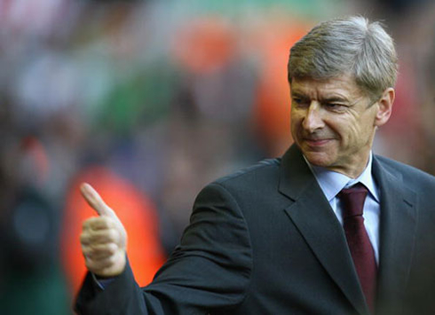 Arsene Wenger showing his thumbs up at Arsenal fans