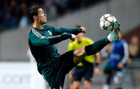 Cristiano Ronaldo showcasing his skills and flexibility in order to reach a ball, in a Real Madrid game in 2012-2013