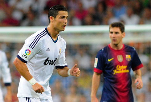 Cristiano Ronaldo crossing in front of Lionel Messi, during a Barcelona vs Real Madrid for La Liga in 2012-2013