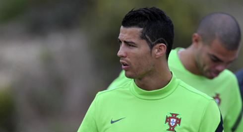 Cristiano Ronaldo new look, with the V letter near his left ear, symbol of the warrior's peace, as he shows his new haircut for 2012-2013