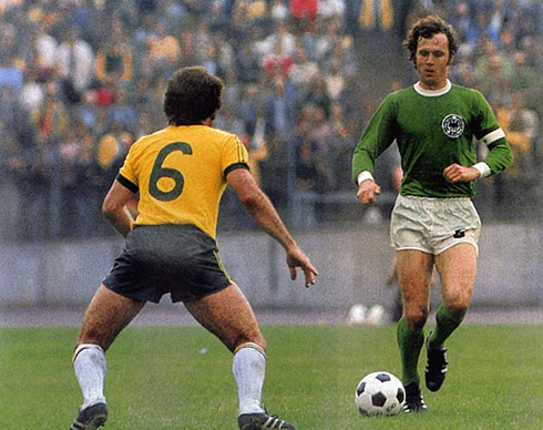Franz Beckenbauer playing in a classic Germany vs Brazil clash, with a green Deutschland shirt, jersey and uniform kit