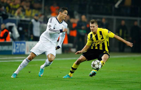 Cristiano Ronaldo switching direction in front of a Borussia Dortmund defender, in 2012-2013