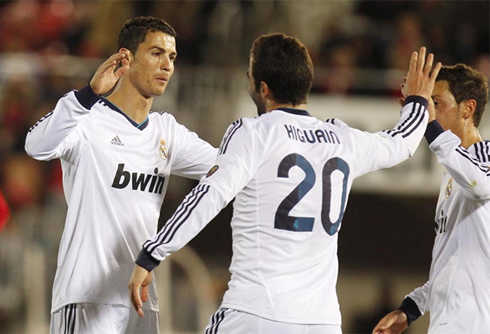 Cristiano Ronaldo with Gonzalo Higuaín and Mesut Ozil, celebrating Real Madrid goal for La Liga, against Mallorca