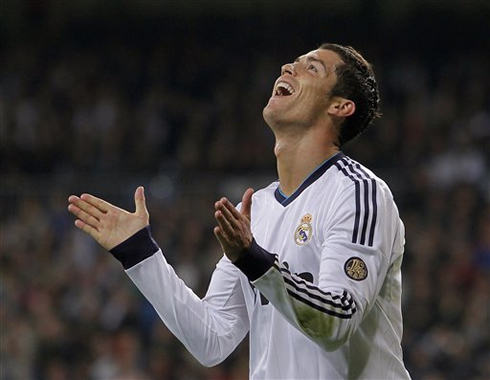 Cristiano Ronaldo not understanding something and showing an ironic smile and reaction during a Real Madrid game, in 2012-2013