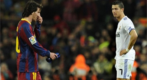 Cristiano Ronaldo looking at Lionel Messi picking up his nose, in Barça vs Real Madrid