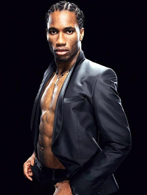 Didier Drogba modelling with an open black shirt, showing off his six pack abs