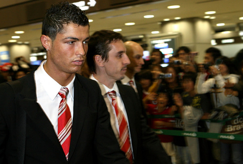 Cristiano Ronaldo and Gary Neville dressed in suits at the airport