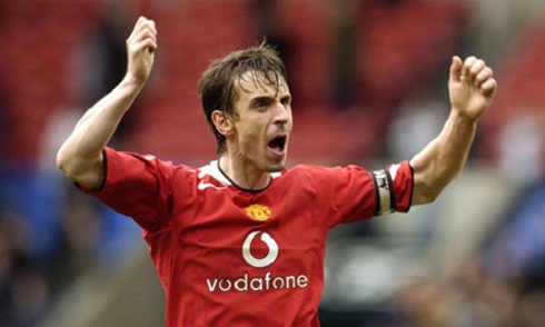 Gary Neville raising his two arms, during a match for Man Utd