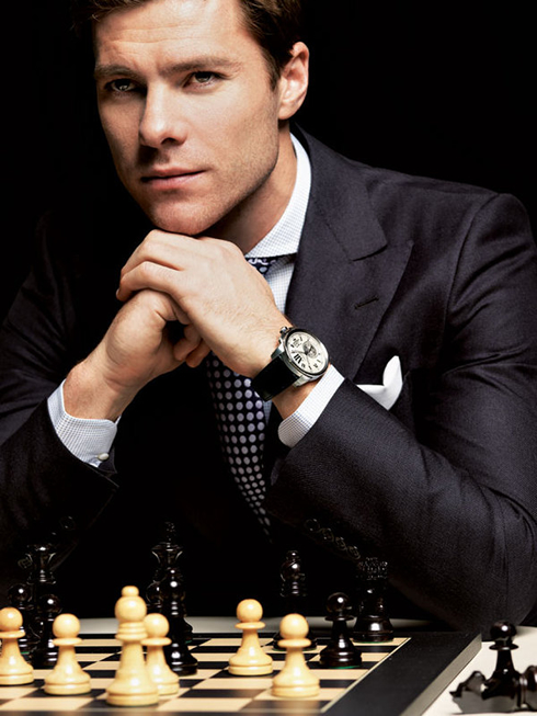 Xabi Alonso playing chess with a nice watch and staring at the camera