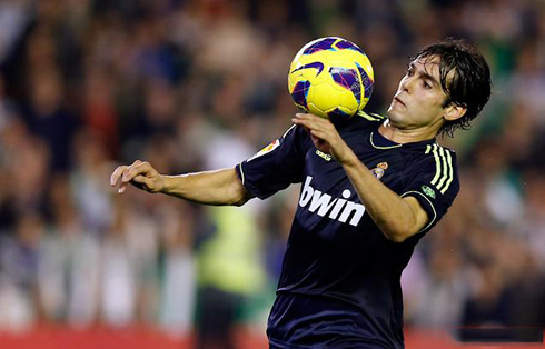 Ricardo Kaká holding the ball near his own shoulder and chest, in Real Madrid vs Betis in 2012-2013