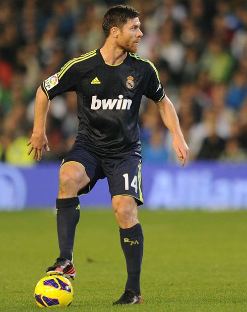 Xabi Alonso perfect ball control, as he tramples the ball during a Real Madrid game in 2012-2013