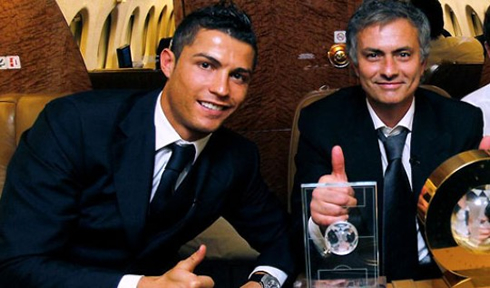 Cristiano Ronaldo and José Mourinho, posing for a photo with the FIFA Balon d'Or award