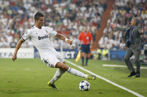 Cristiano Ronaldo controlling a ball with José Mourinho on his back sending instructions to other players