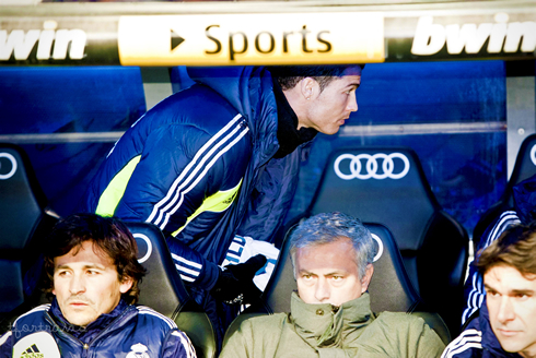 Cristiano Ronaldo standing behind José Mourinho, in Real Madrid bench, in 2012-2013