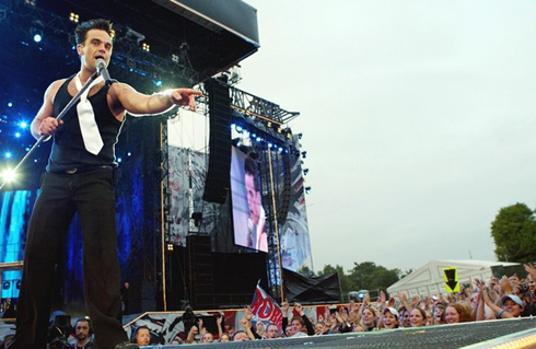 Robbie Williams in a live concert tour