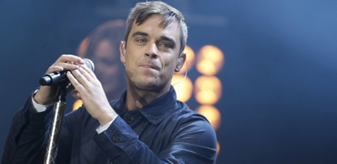Robbie Williams performing live on stage