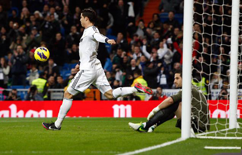 Cristiano Ronaldo kicking the ball high, after he had just scored a goal for Real Madrid, in 2012-2013