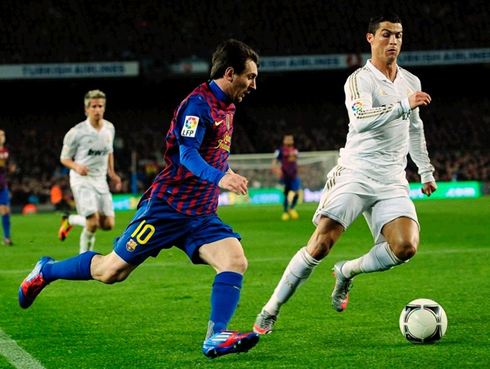 Cristiano Ronaldo chasing Lionel Messi on the field