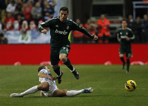 Cristiano Ronaldo running over a Malaga defender, in a game for Real Madrid