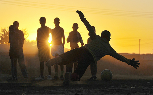 Kids playing football and soccer in Africa