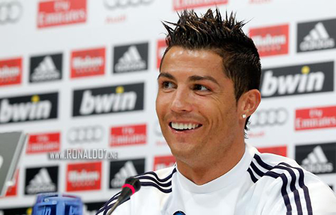 Cristiano Ronaldo looking sideways and showing his extra white teeth, in 2013