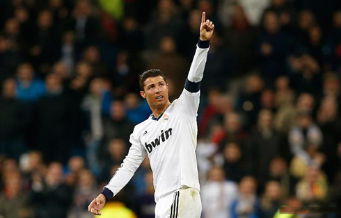 Cristiano Ronaldo raising his finger in the air and pointing above, during a Real Madrid match in 2013